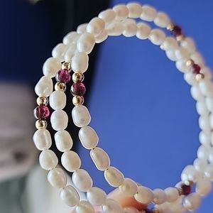 Freshwater pearls, gold beads, and semiprecious stone.
